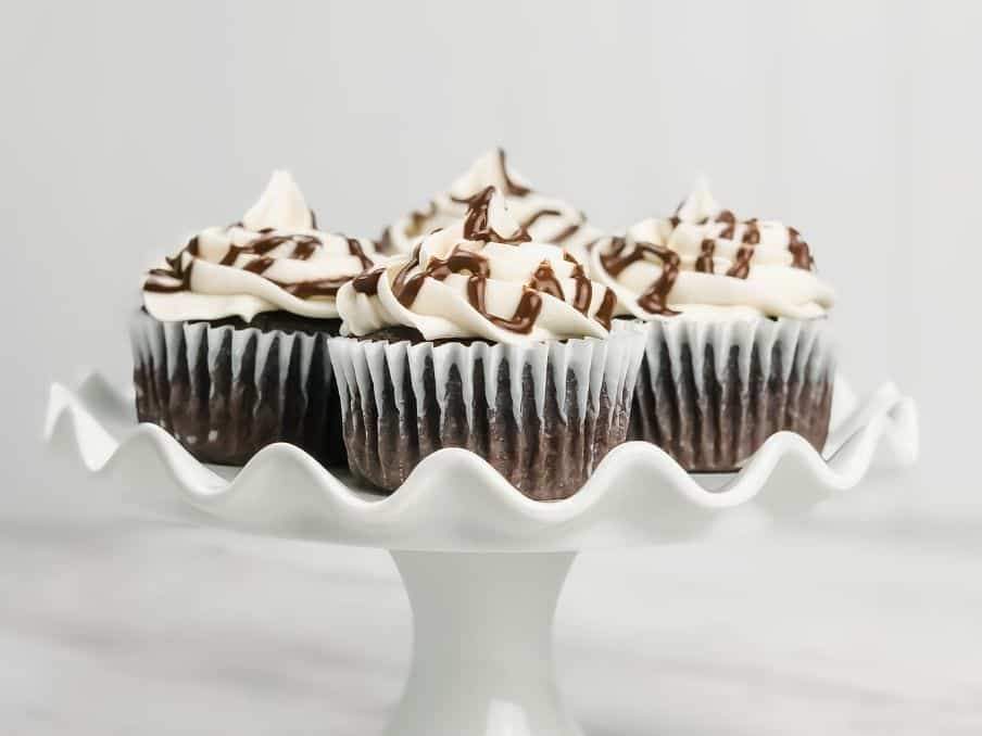 gluten free vegan hot chocoalte cupcakes on a white serving tray on a white countertop